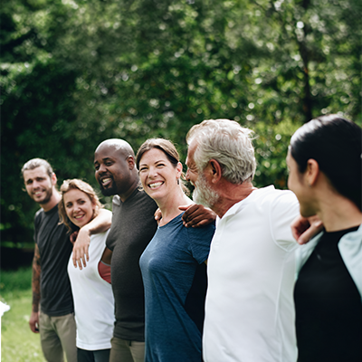 Diverse group of smiling people standing together outdoors